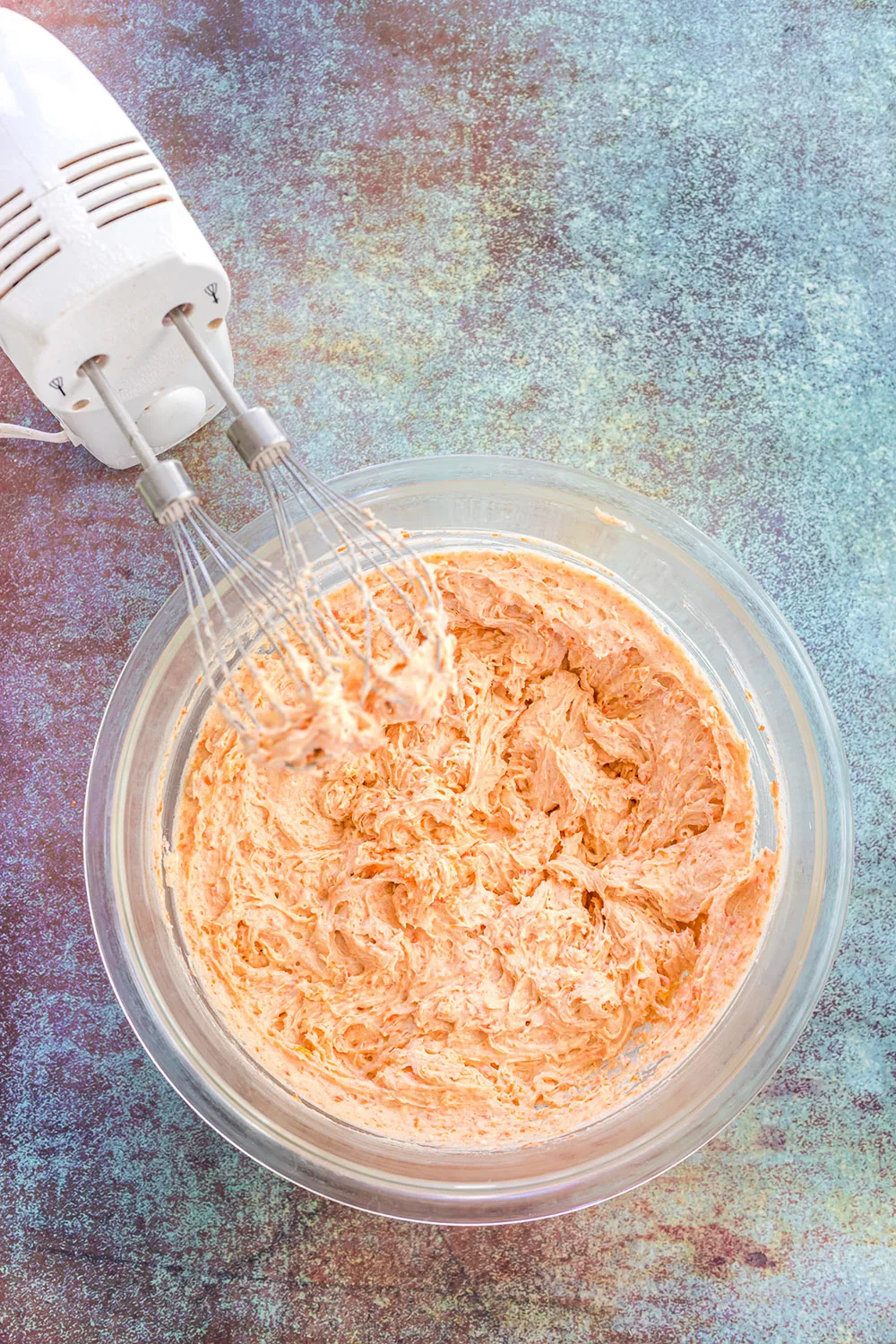 Carrot cookie batter in a mixing bowl.