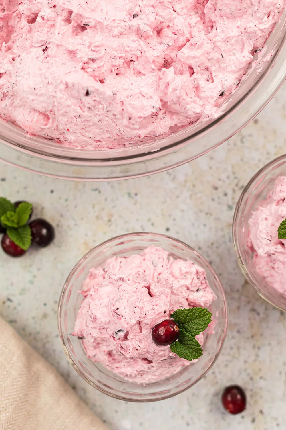 Clear bowls filled with pink whipped cranberry salad.
