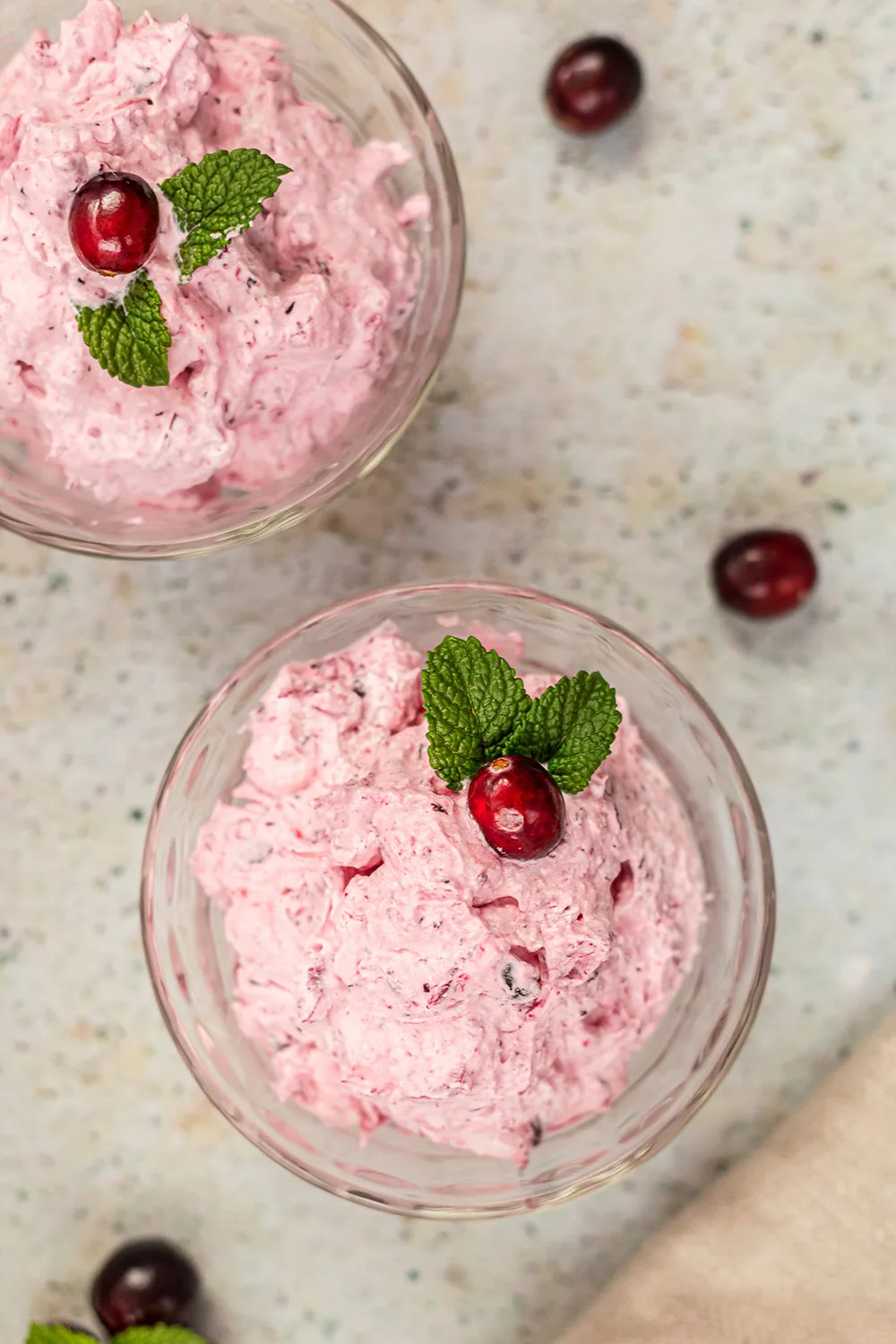 Bowls of whipped salad topped with cranberries.