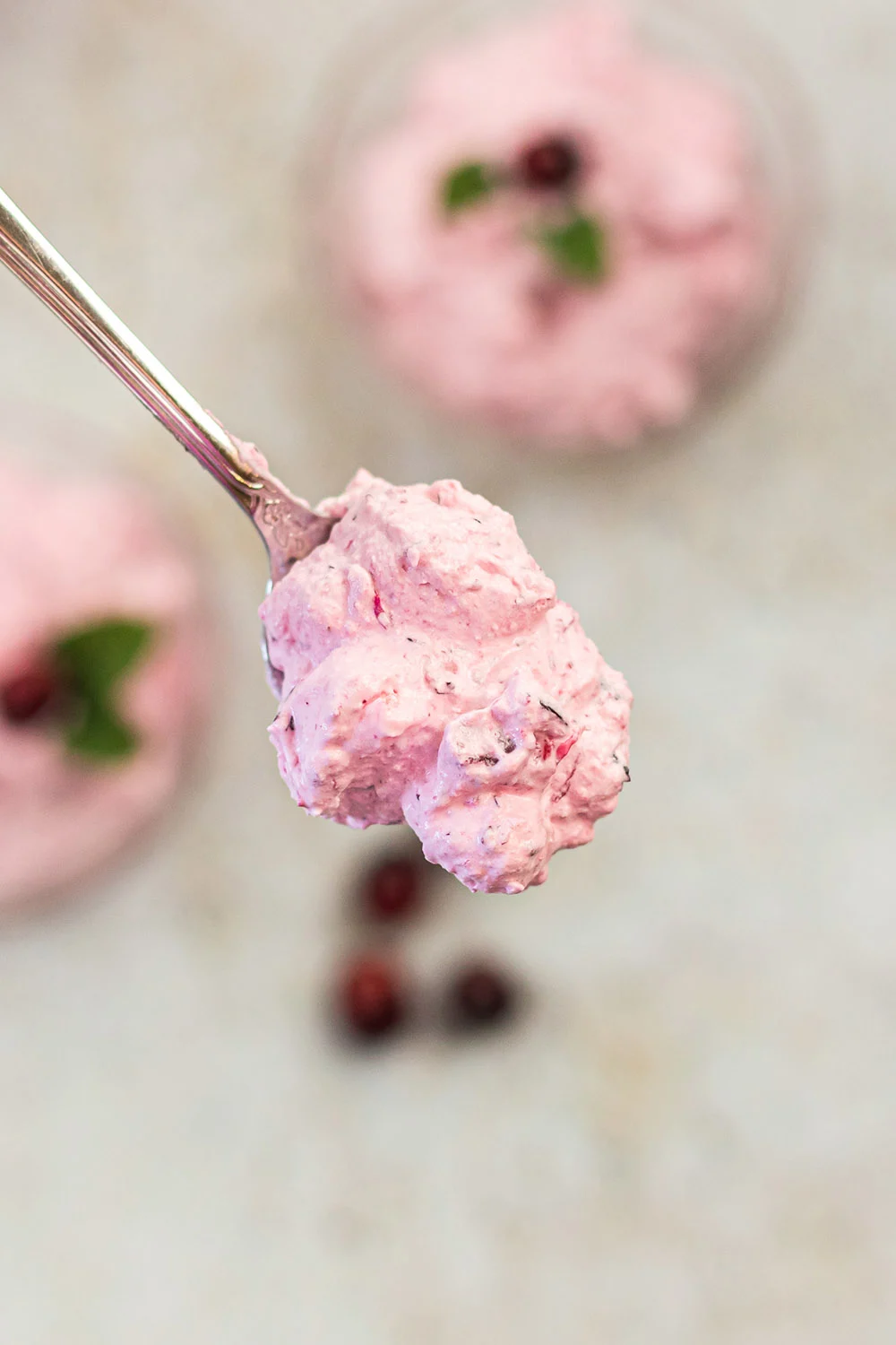 Spoon full of pink whipped cranberry salad.