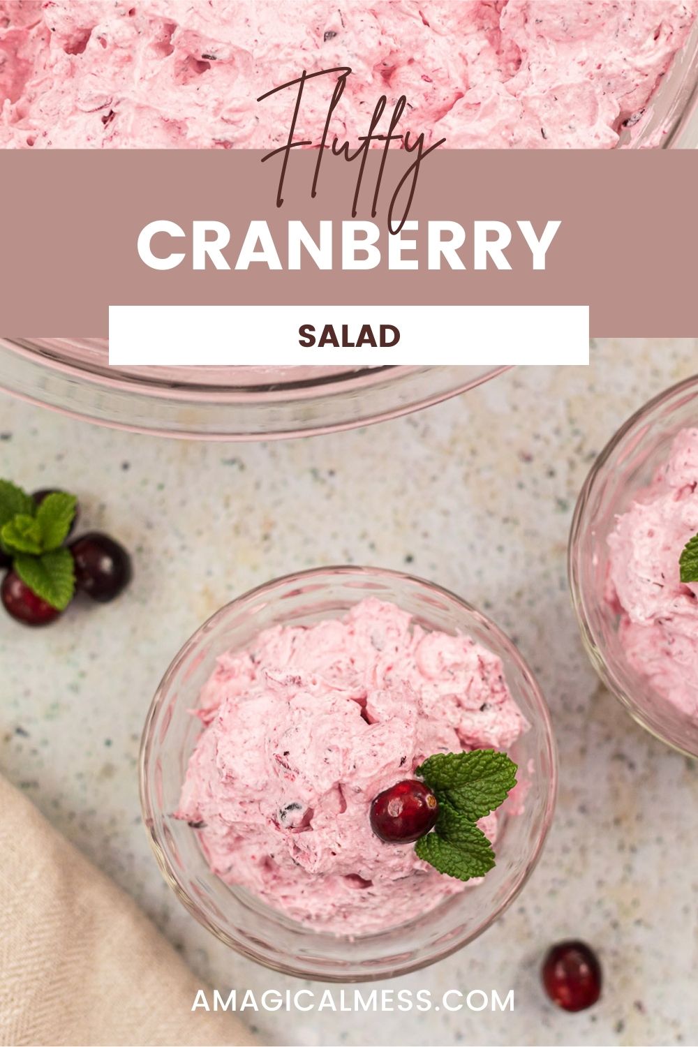 Bowls filled with pink fluffy cranberry salad topped with cranberries.