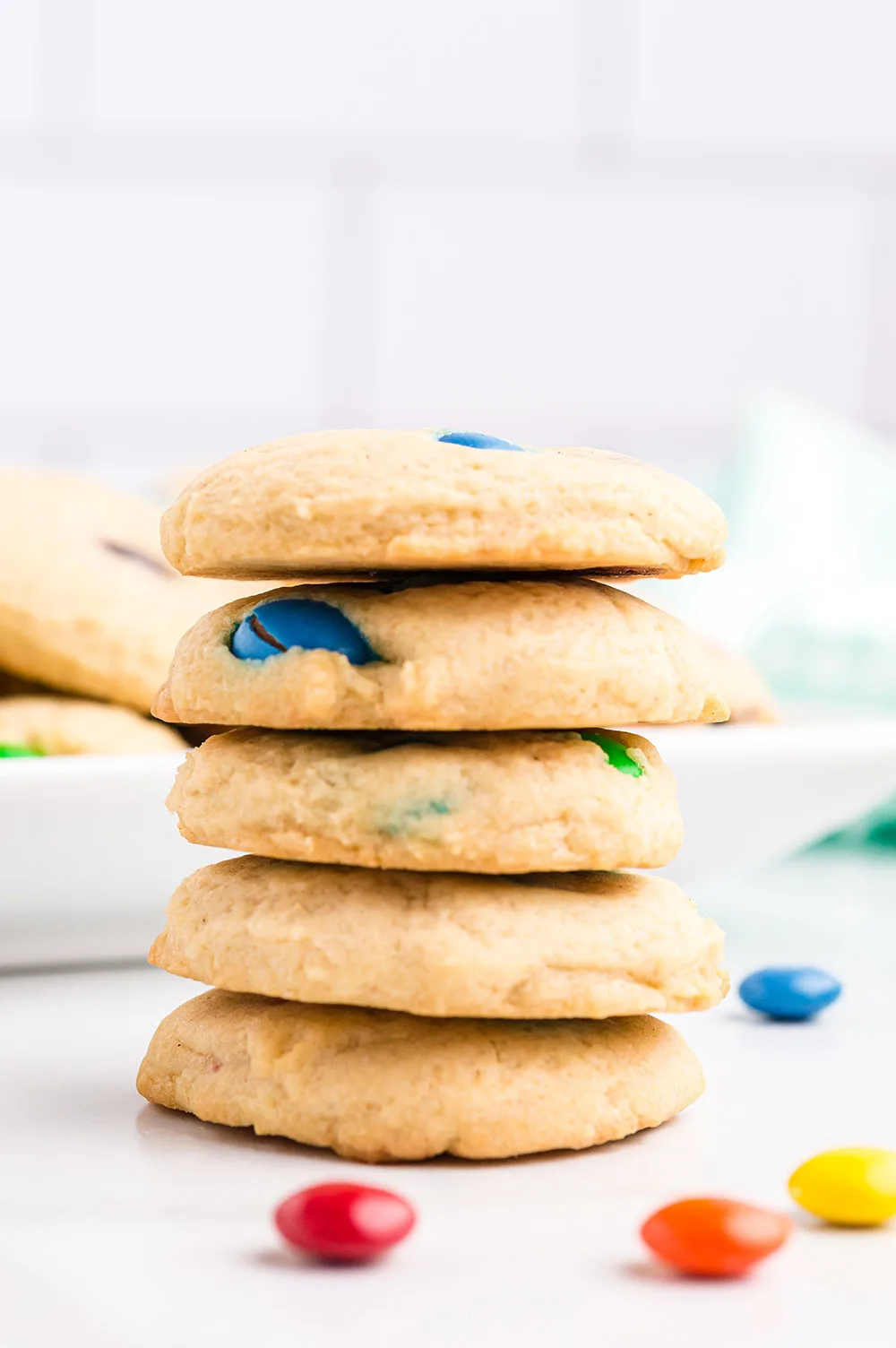 Stack of cookies with M&M candies on the table.