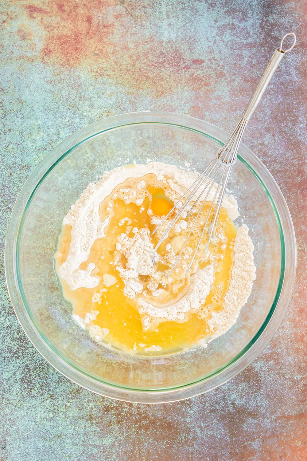 Four and egg in a mixing bowl.