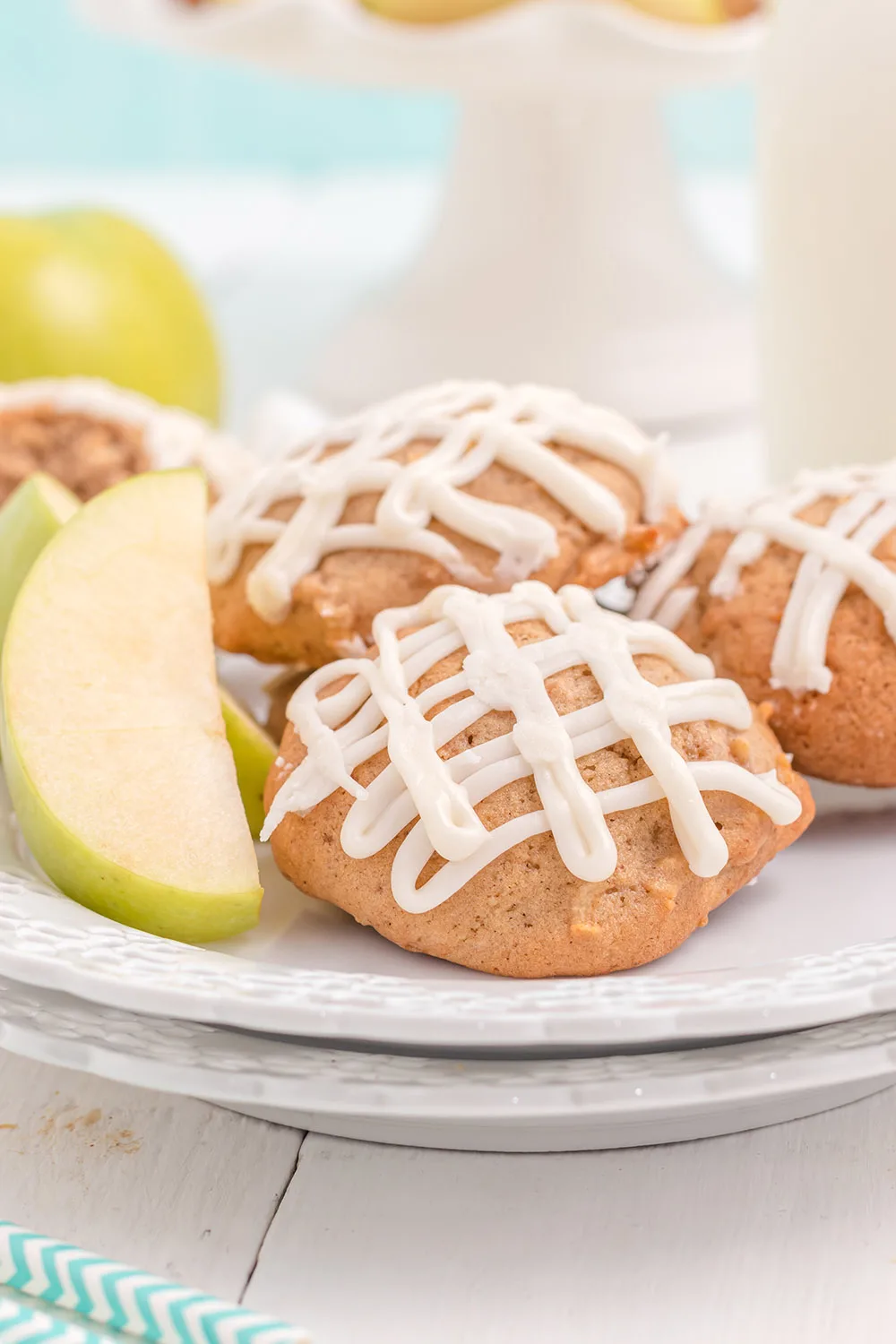 Glazed apple cookies on a plate.