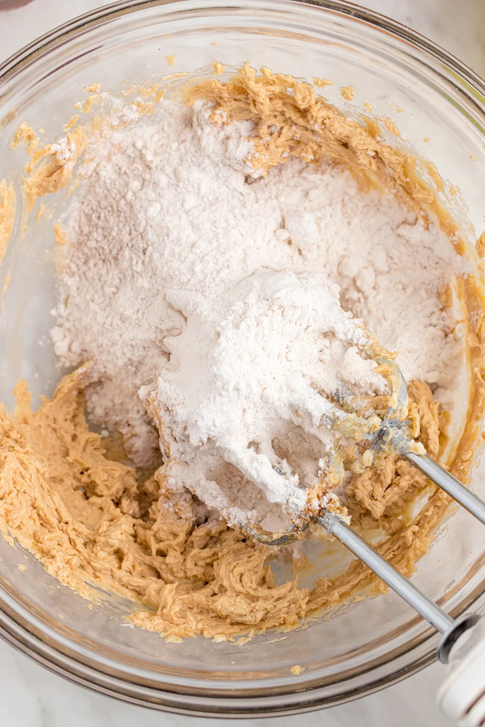 Flour on top of batter in a bowl.