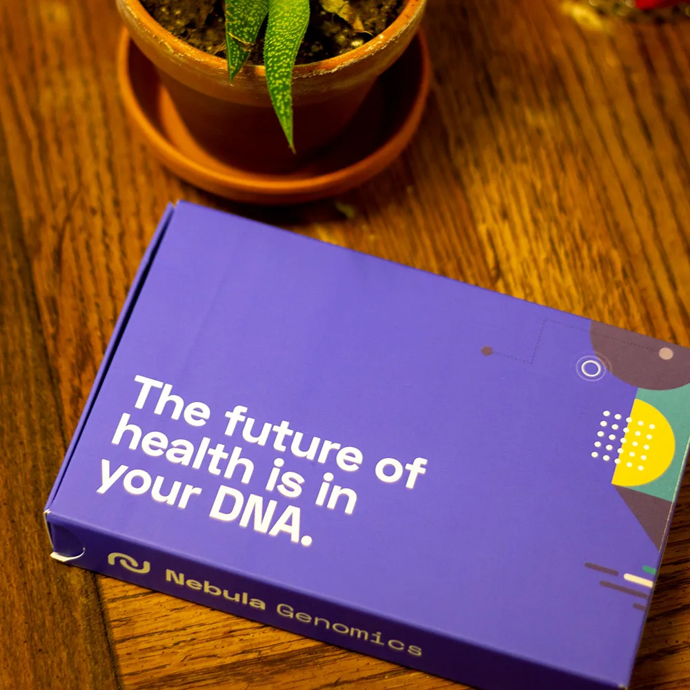 Nebula Genomics box on a wood table next to a succulent.