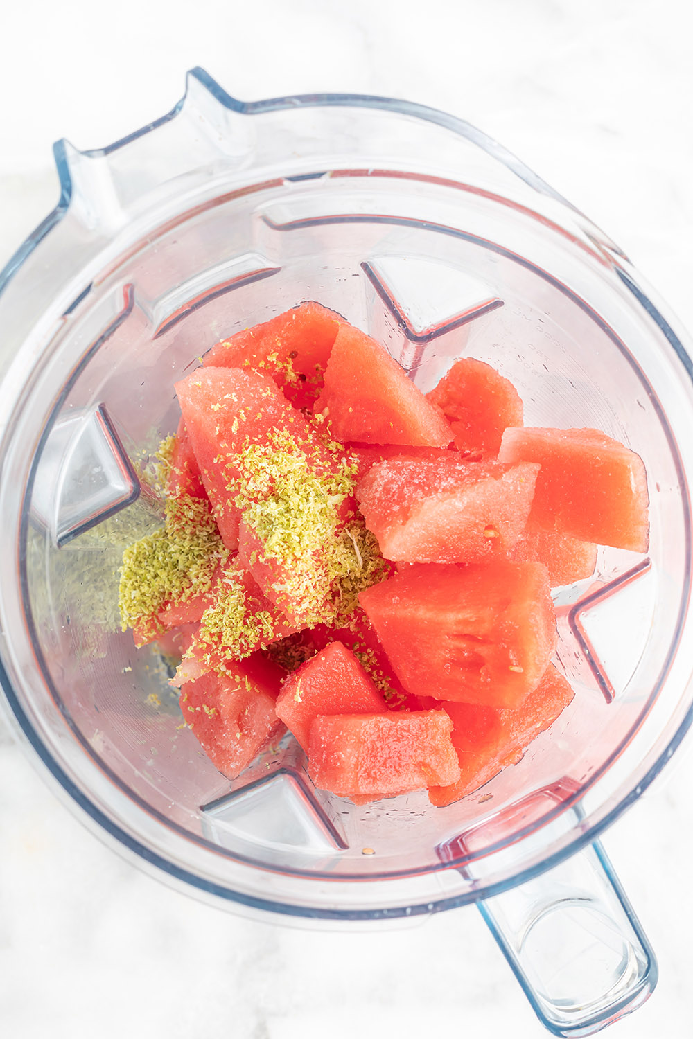 Watermelon and lime zest in a blender.