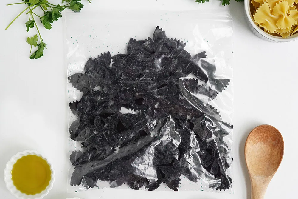 Black bowtie pasta in a bag.