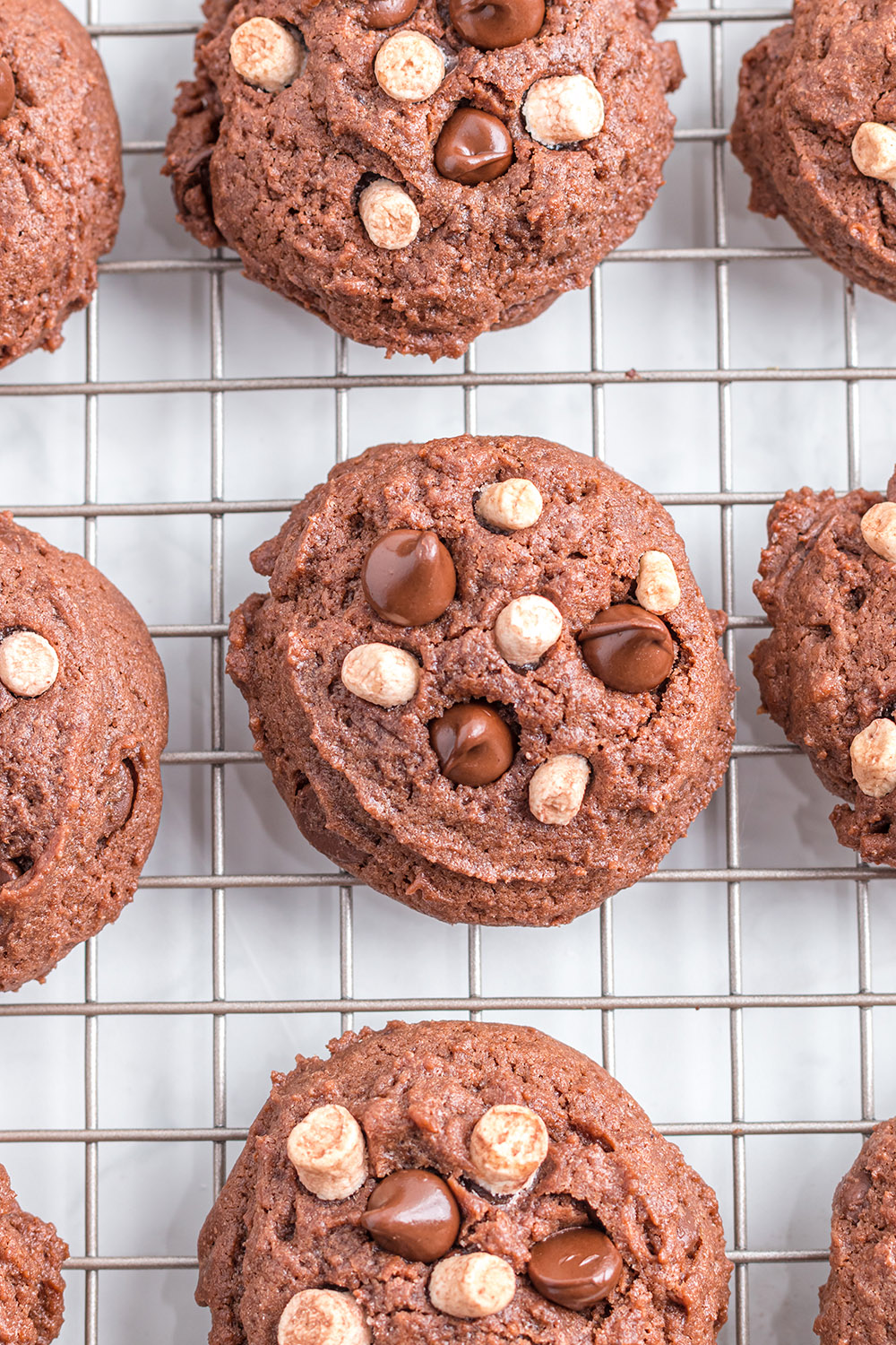 Baked hot cocoa cookies on a cooling rack.