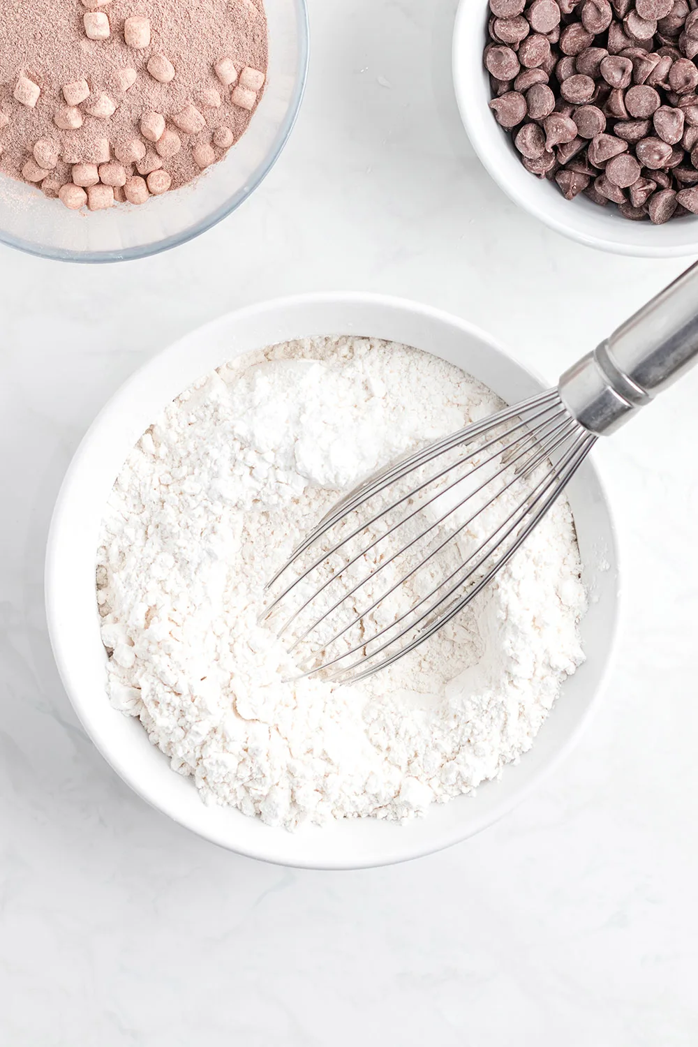 Flour mixture in a bowl with a whisk.