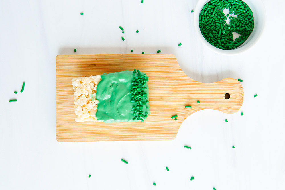 Green sprinkles on a treat with melted candy. 