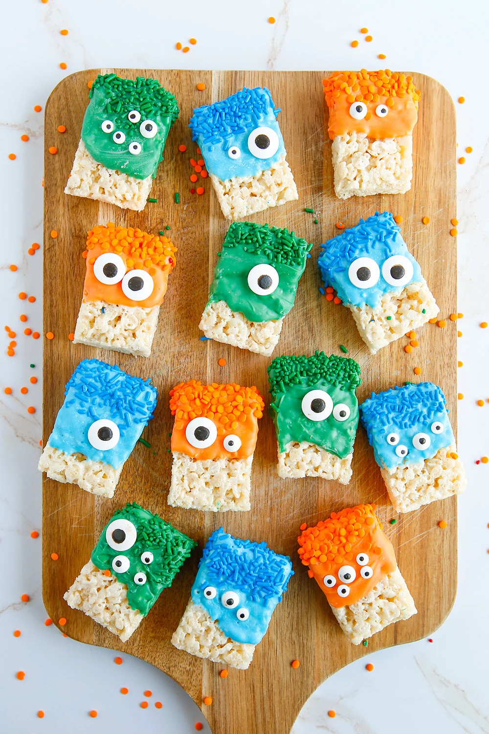 Rows of crispy treats decorated as monsters for Halloween. 