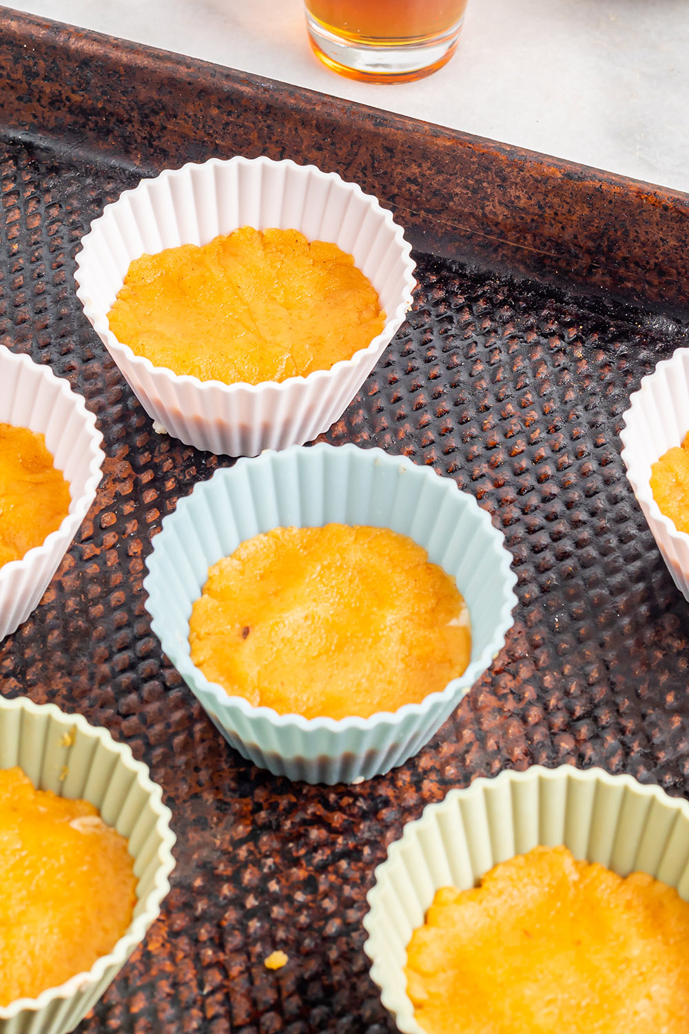 Pumpkin mixture in cupcake liners. 