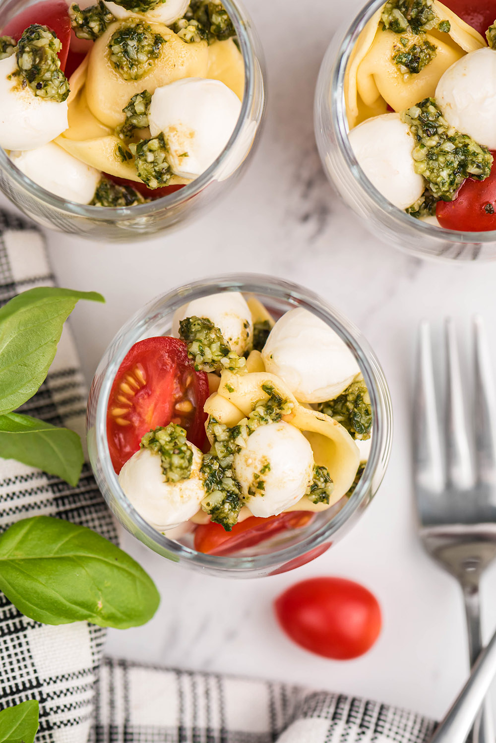 Overhead image of caprese salad shooters in glasses. 
