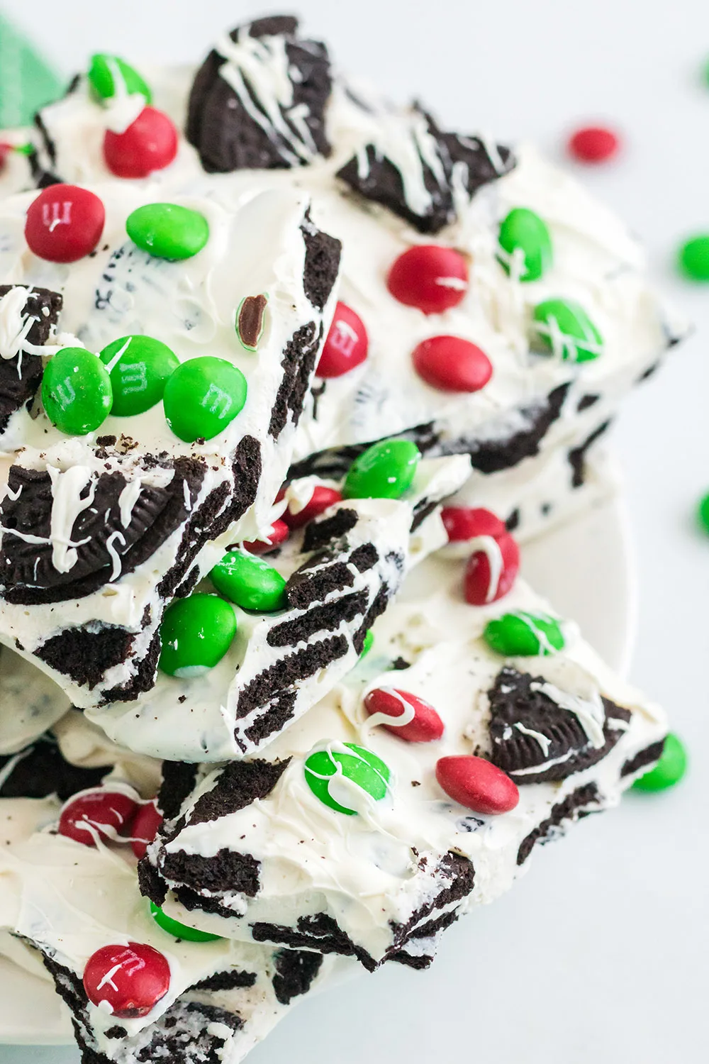 Plate full of holiday oreo bark candy with m&ms. 