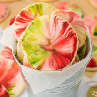 Holiday marble cookies in a tin bucket and on a table.