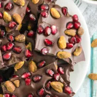 Dark chocolate candy with pistachios and pomegranate arils in it.