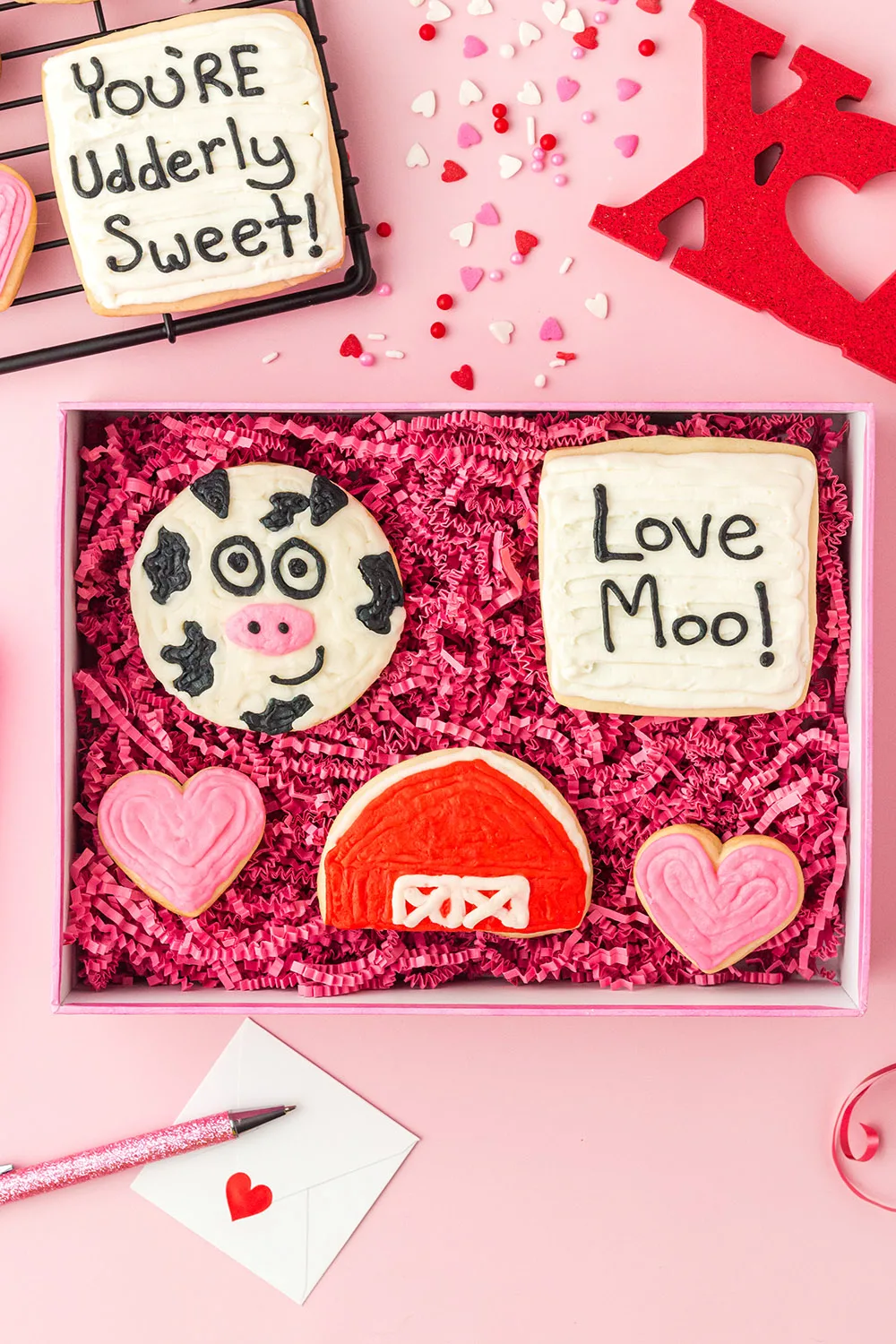 Valentine cut out sugar cookies in a cow farm theme in a gift box. 