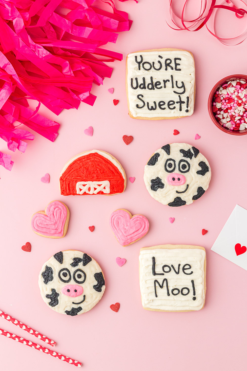 Decorated Valentine cow cookies on a table. 