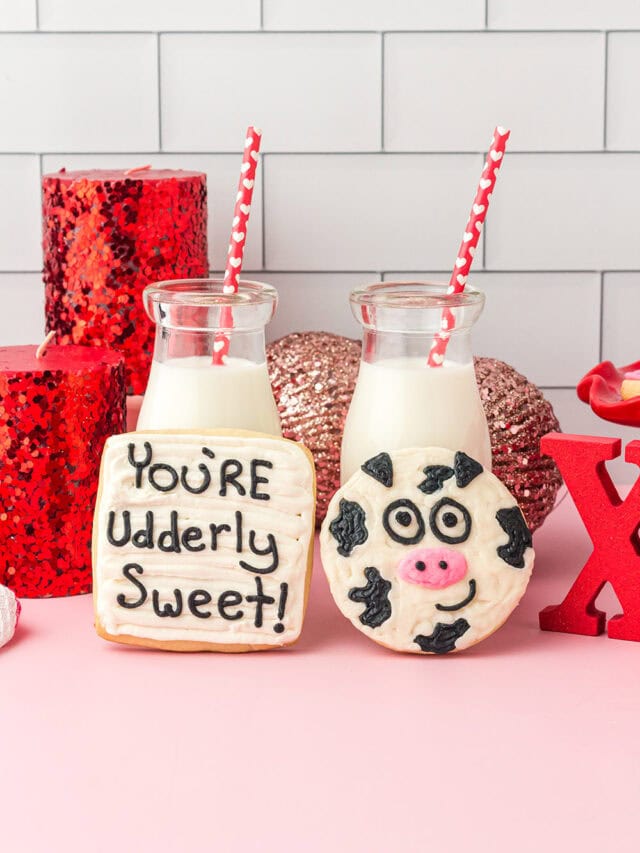 You're Udderly Sweet and a cow Valentine's themed cookies next to milk on a table.