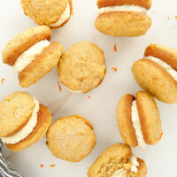 Carrot cake whoopie pies on a table.
