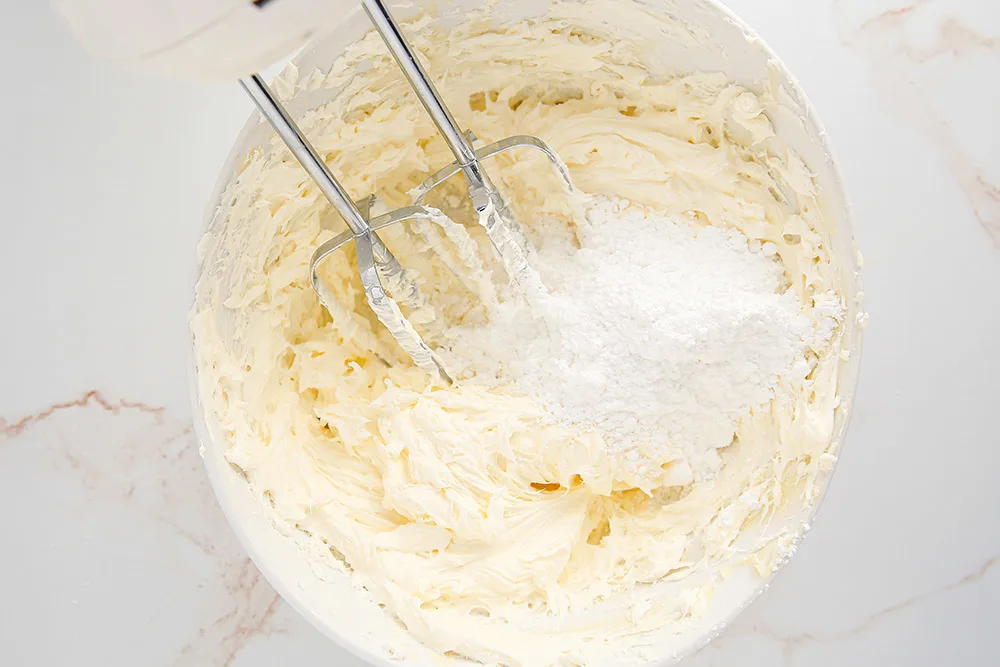 Frosting in a bowl with a mixer. 
