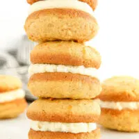 Stacked carrot whoopie pies with cream cheese filling.