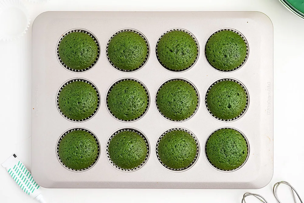 Green cupcakes in a baking tin.