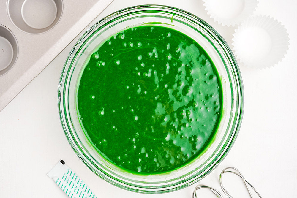 Green batter in a clear mixing bowl.