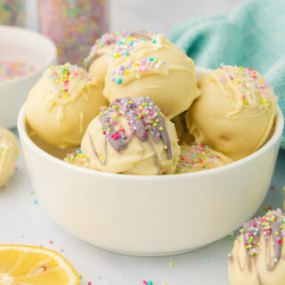 A bowl of lemon truffles with spring decorations.