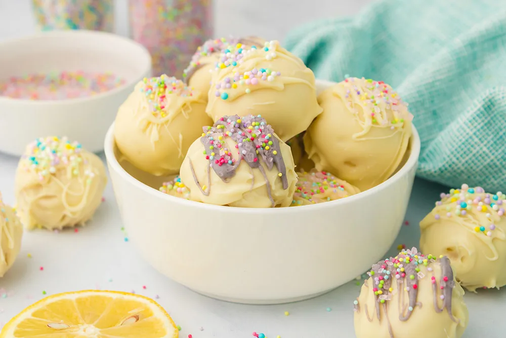 A bowl of lemon truffles with spring decorations.