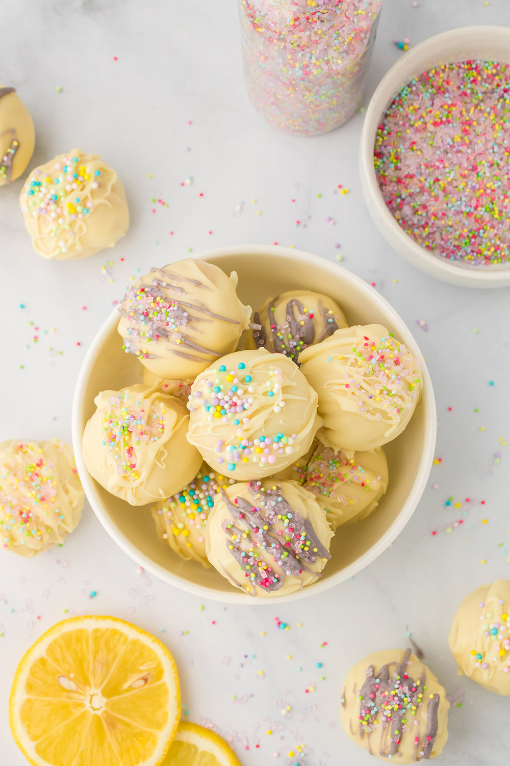 Bowl of lemon truffles with spring decorations.