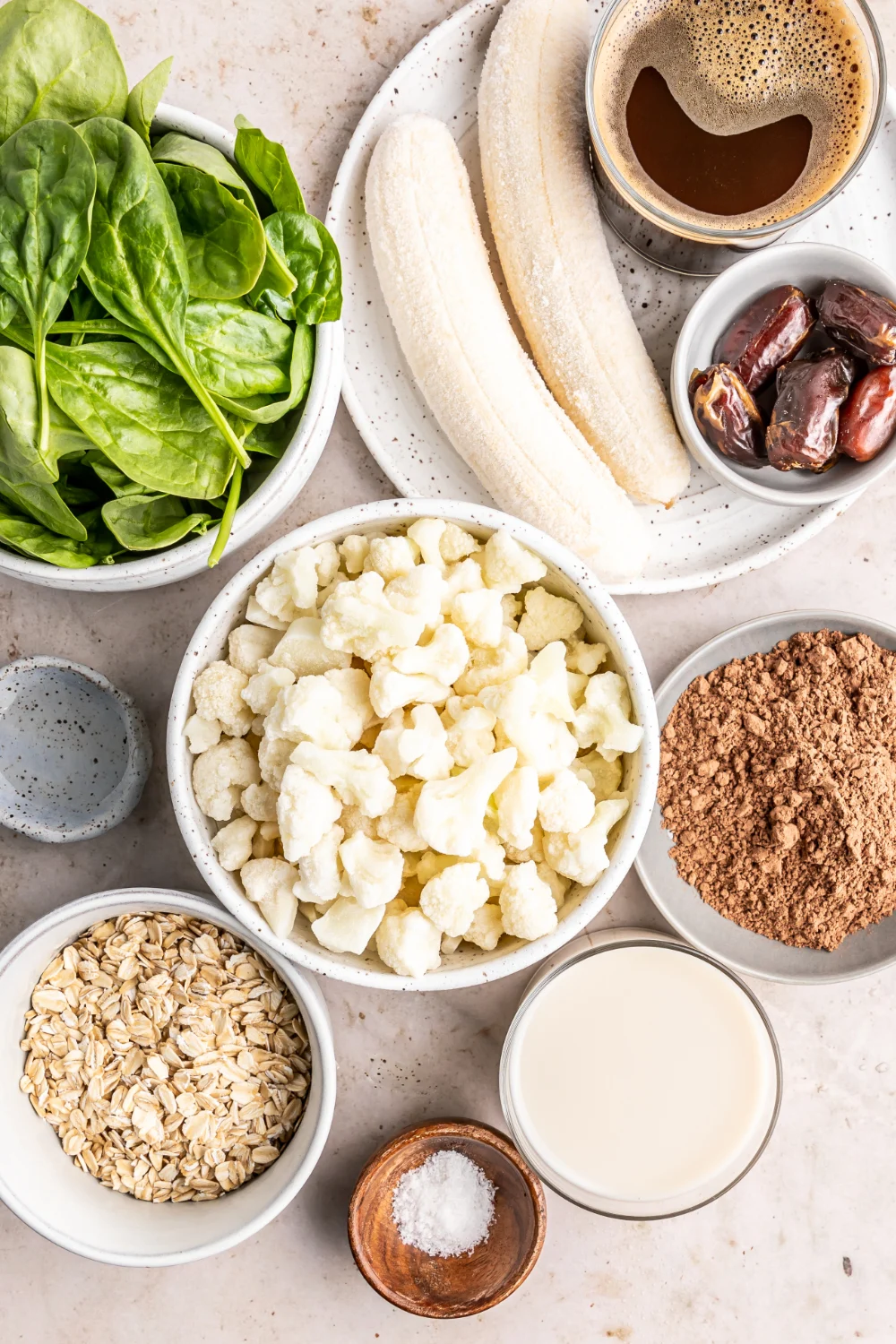 Mint, bananas, cauliflower, and other ingredients for a smoothie in bowls. 