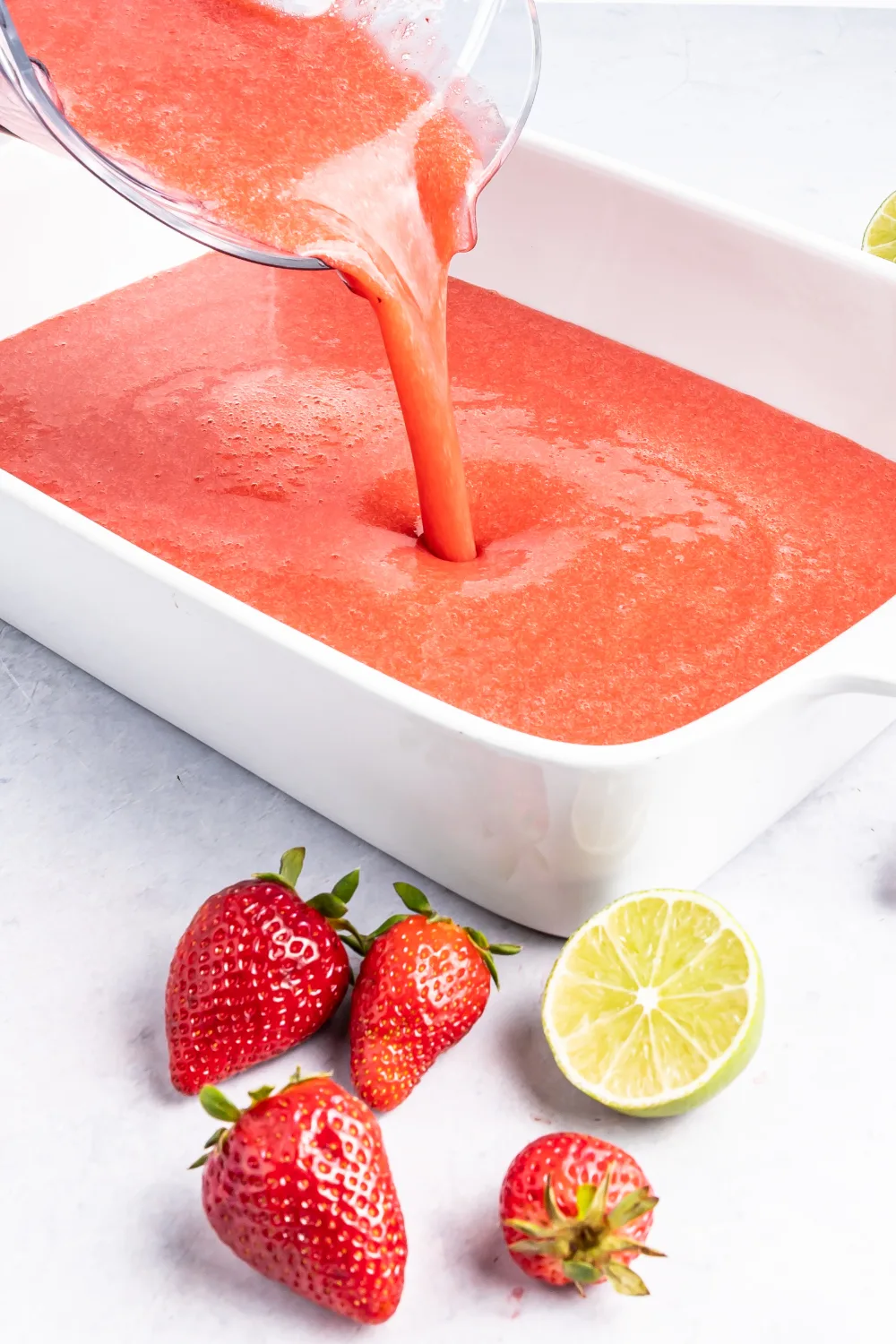 Pouring mixed granita into a shallow dish. 