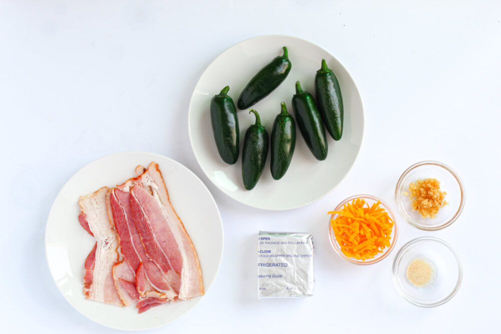 Bacon, jalepenos, cream cheese, and other ingredients for poppers. 