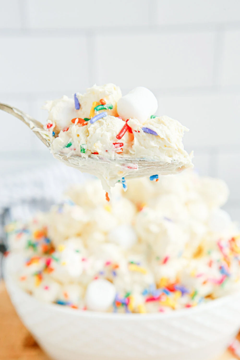 Spoon full of birthday marshmallow fluff salad. 