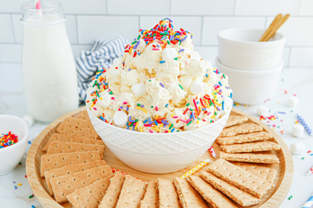 Funfetti fluff in a bowl with graham crackers around. 