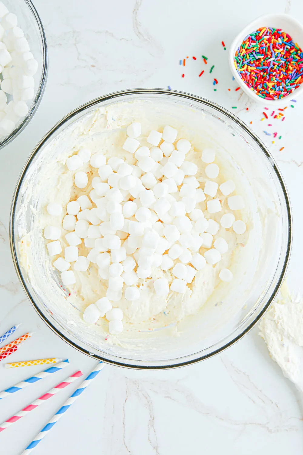 Marshmallows in the bowl with pudding mixture. 