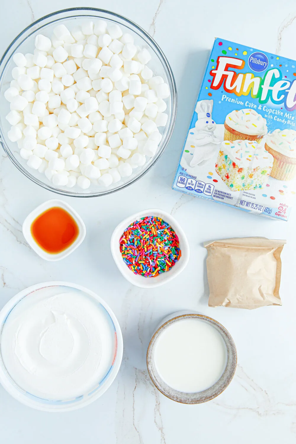 Marshmallows, funfetti cake mix, sprinkles, and other ingredients for fluff salad. 