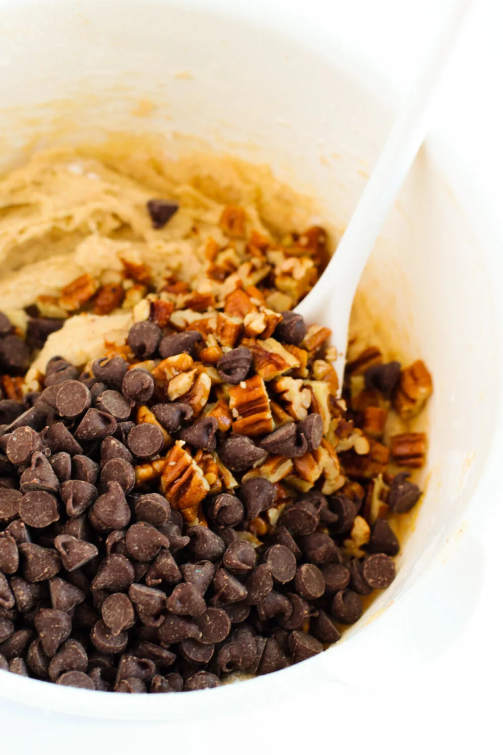 Chocolate chips and pecans in cookie batter. 