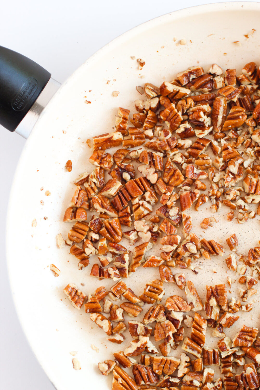 Chopped pecans in a skillet. 