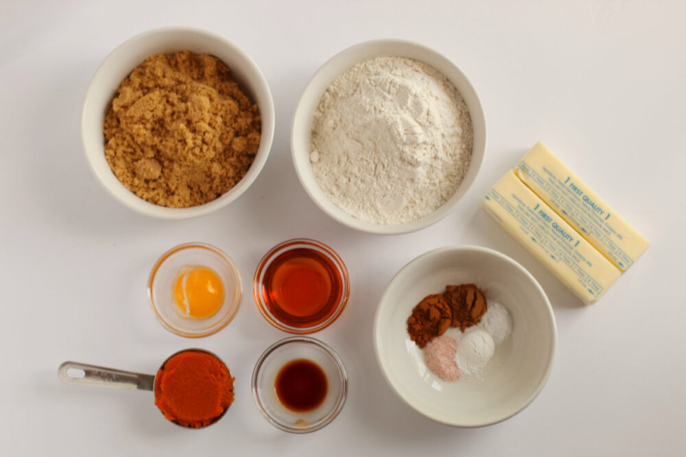 Butter, brown sugar, flour, and other ingredients for cookies on a table. 