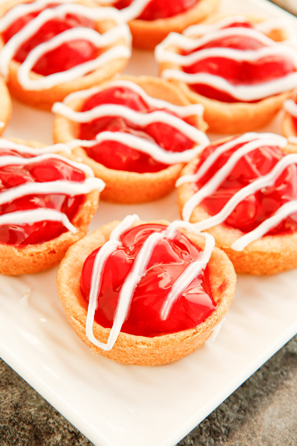 Cherry pie cookies topped with glaze. 