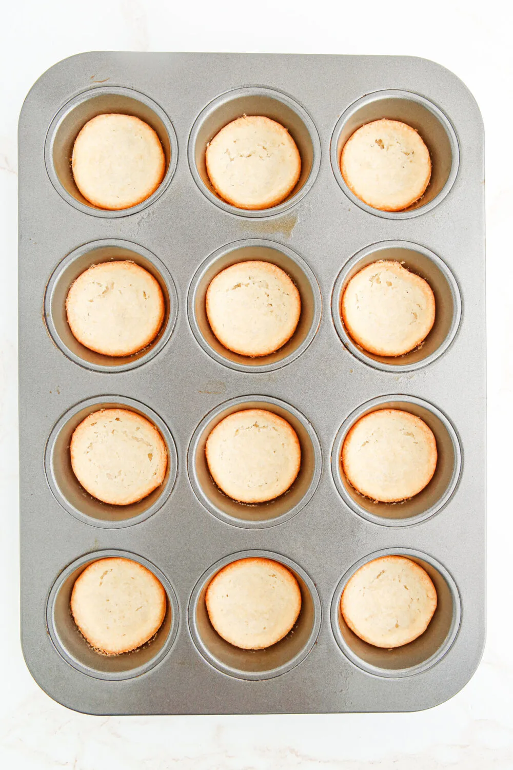 Baked sugar cookie crusts in muffin tins. 