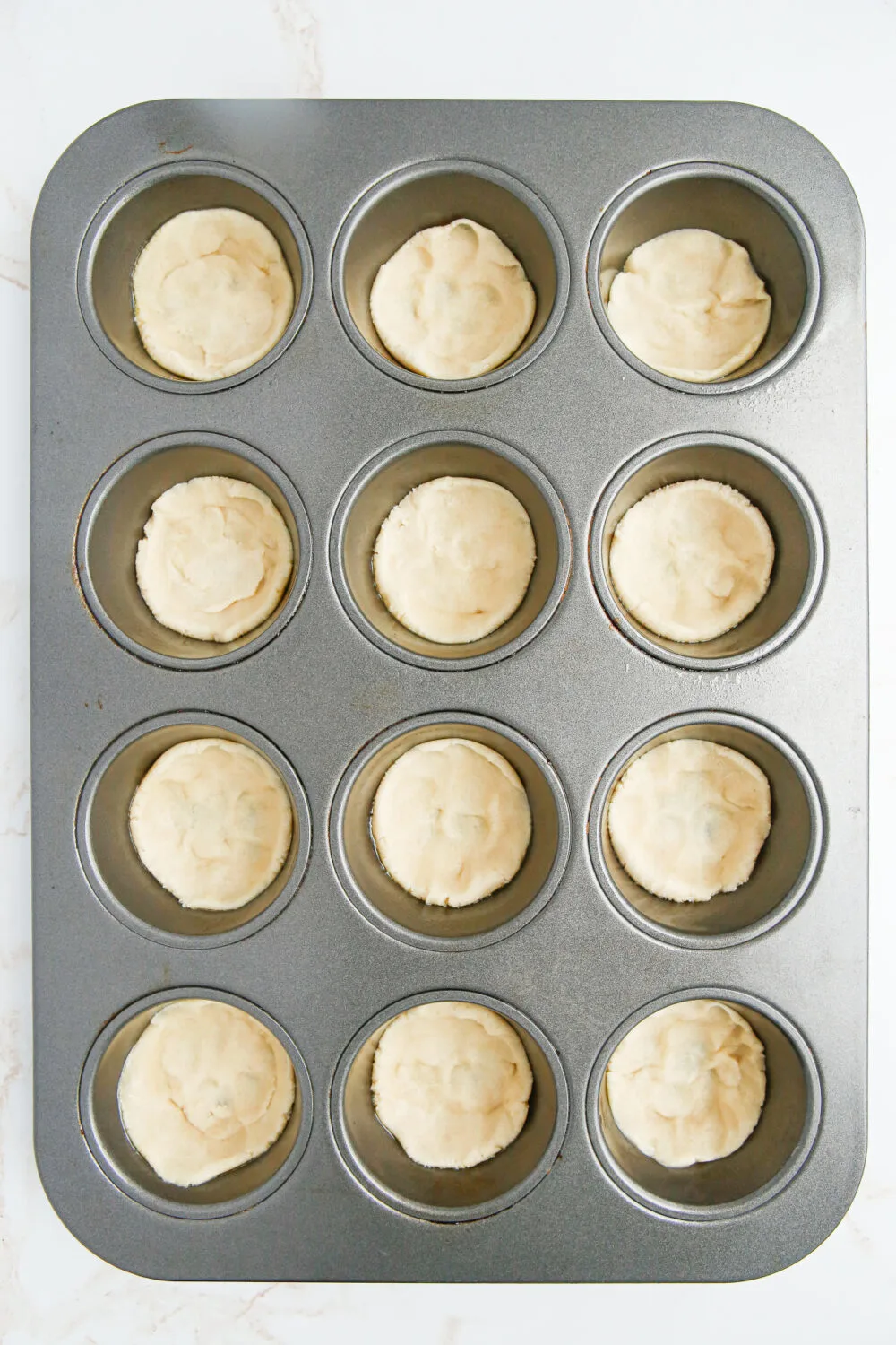 Sugar cookie dough in muffin tins. 