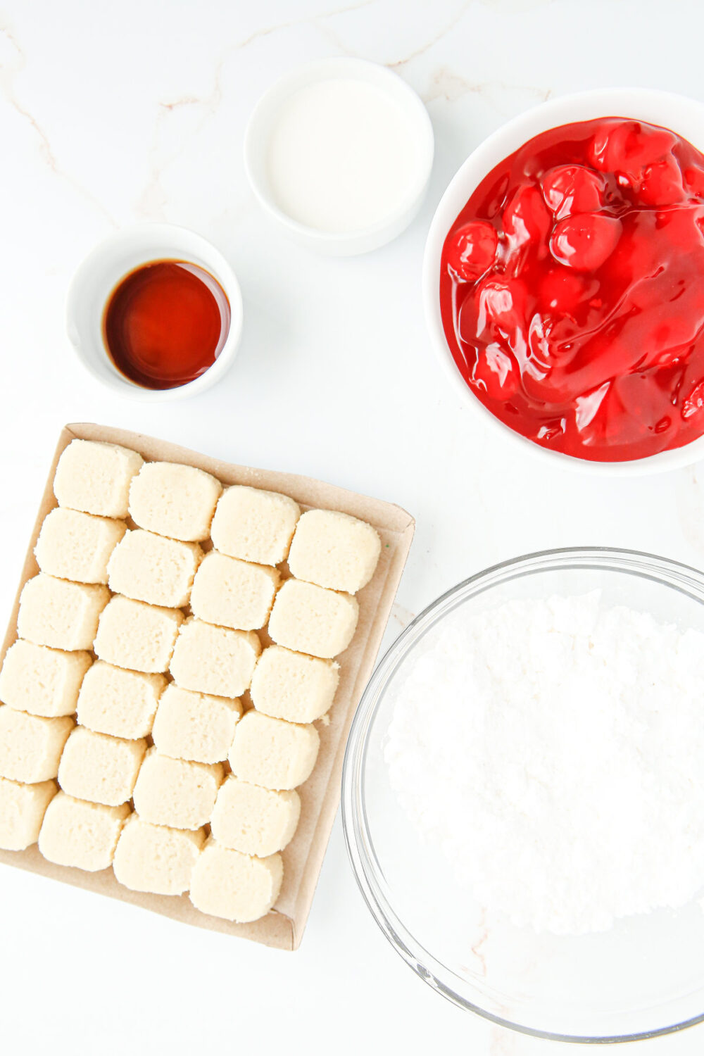Cherries, sugar cookie dough, and other ingredients to make cherry pie cookies.