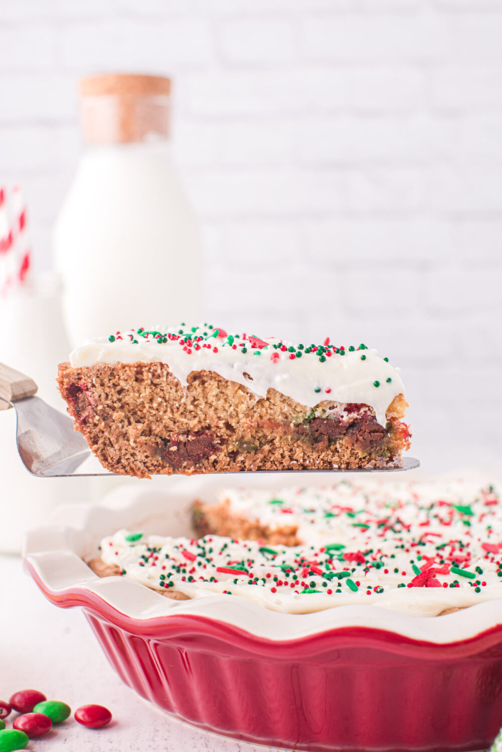 A slice of Christmas sugar cookie pie on a pie spatula. 