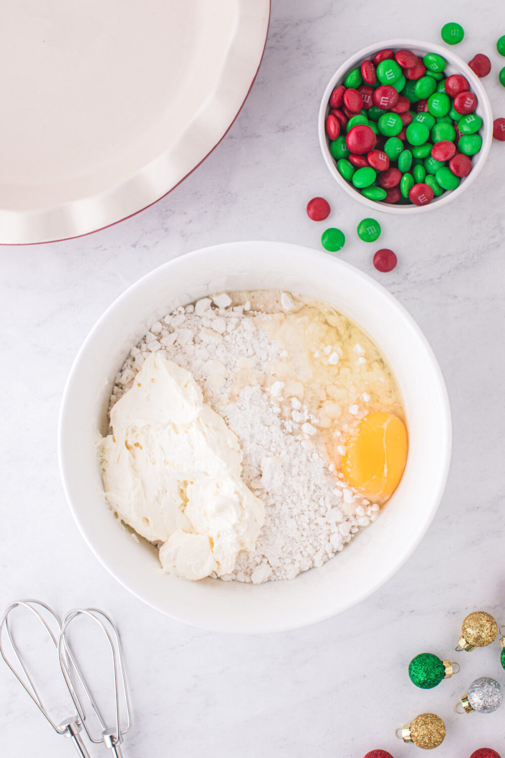 Sugar cookie mix and egg in a mixing bowl. 