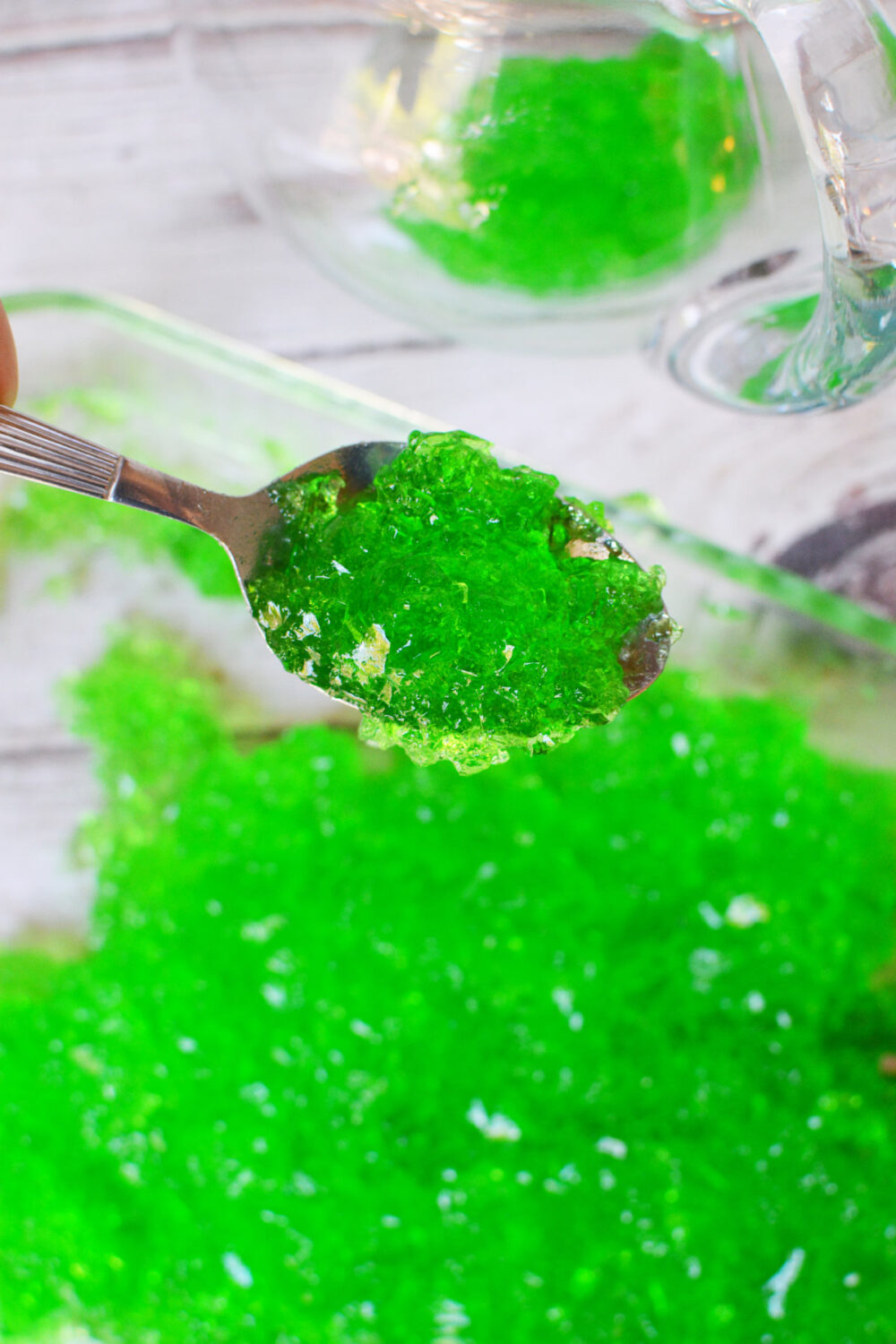Shredded green jello on a spoon.