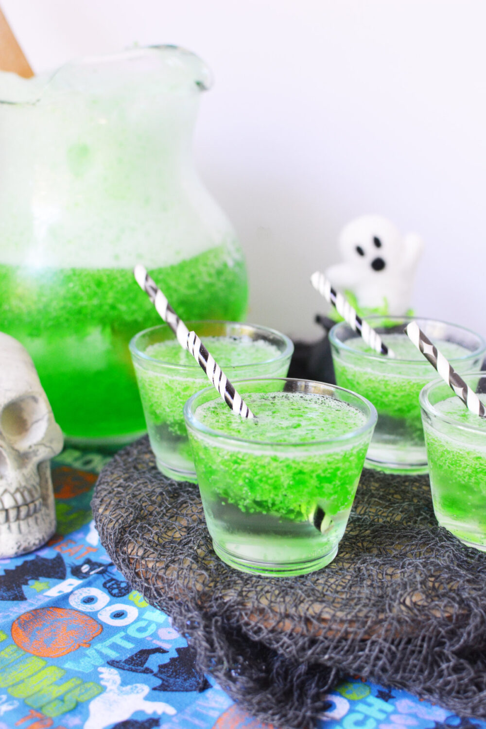 Cups of green jello smile Halloween drink. 